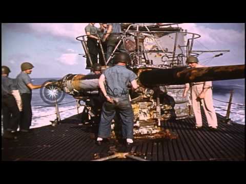 Sailors manning battle stations and fire guns aboard USS Barb submarine in Pacifi...HD Stock Footage