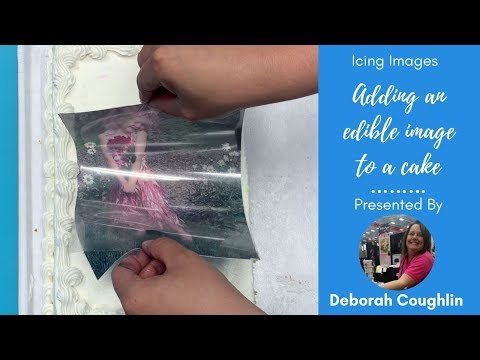 Part of a video titled How to apply an edible image to a buttercream or fondant cake