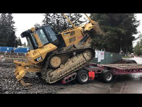 Loading a cat dozer over the rear of a transport trailer