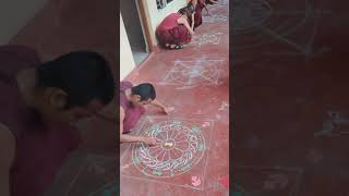 They are learning to draw Chakra which is used during Fire Puja.