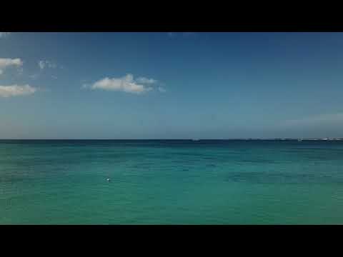 casa caribe unit 18 beach w joggers and a flyover of the Beachcomber Reef