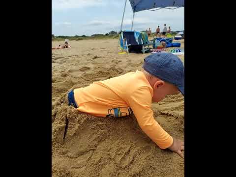 Luke playing at the beach with Dada