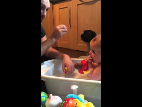 Baby laughing at dog and squeaky duck!