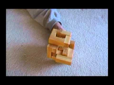 Solve the wooden block century cube puzzle.flv
