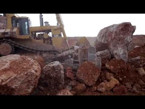 Caterpillar D11R pushing a massive rock 1