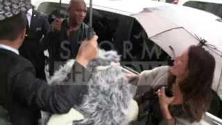 Miley Cyrus and HUGE teddy bear in the pouring rain in Paris