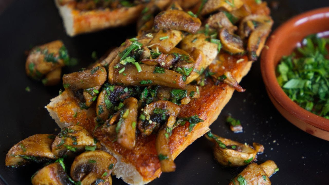 a slice of toasted bread topped with garlic mushrooms and paprika