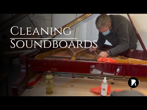Cleaning under the strings of a grand piano