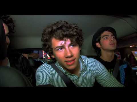 Official trailer frame from the Jonas Brothers 3D concert film with stage lights and audience