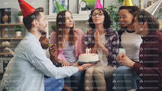 Download lagu Young lady making wish blowing candles on birthday cake at party with friends mp3 Download lagu Young lady making wish blowing candles on birthday cake at party with friends mp3