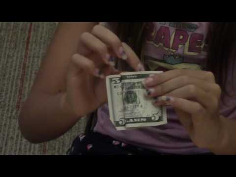 Part of a video titled How to Connect 2 Paper Clips With a Dollar Bill - YouTube