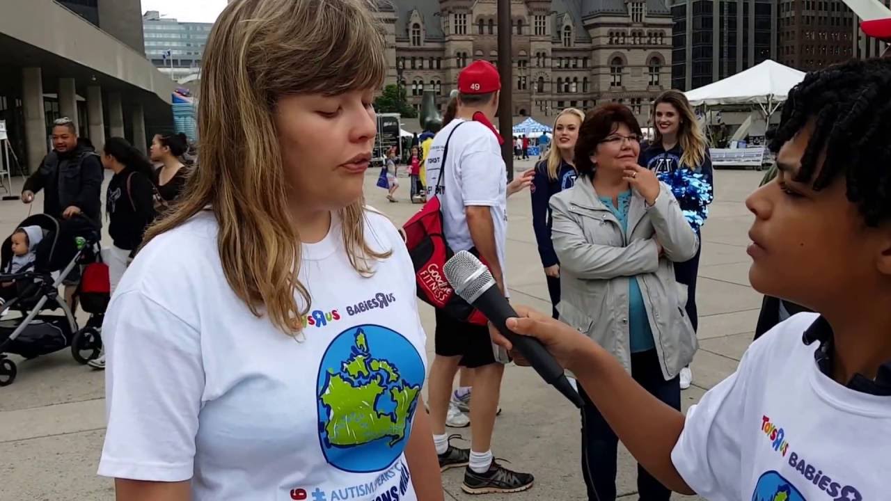 Graham Saunders interviewing people at the Autism Speaks, including his father Chief Mark Saunders