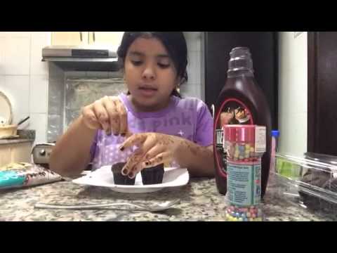 Decorating the chocolate cupcakes by Nouf