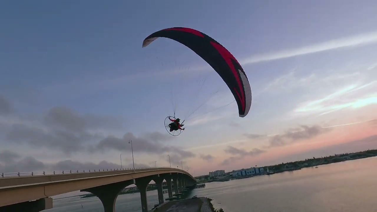 Aerial drone shot following a paramotor in flight — Propelling Views Tampa Bay