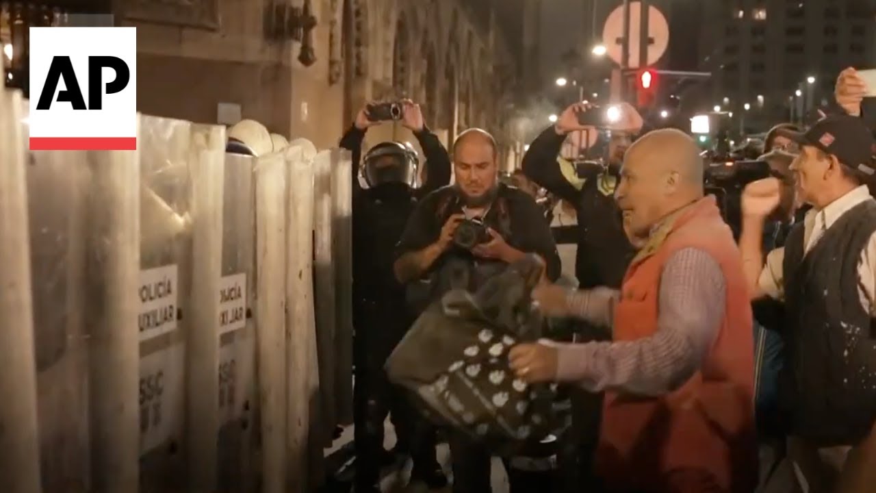 Tense scenes as protesters face off with police after shutting down Mexico Senate