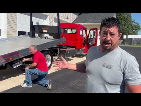 How to use and operate a tow truck operating a rollback load a car