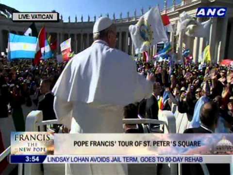 Pope Francis waves as he arrives in Saint Peter's Square for his inaugural mass