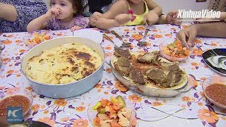 Egyptians enjoy traditional food "Fattah" at Eid festival