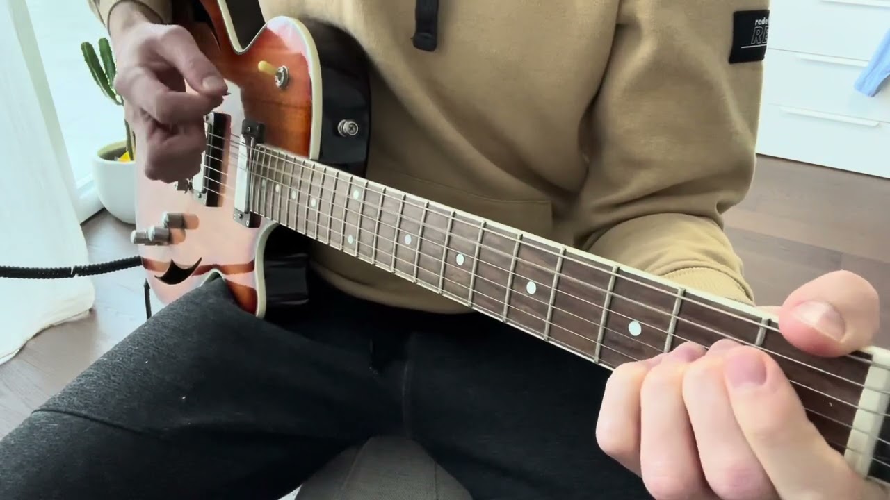 Guitar close-up demonstrating the Venus strumming pattern by Shocking Blue over an Em chord
