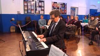 Howard Blake performing &#39;Walking in the Air&#39; on piano at Downs Junior School, Brighton