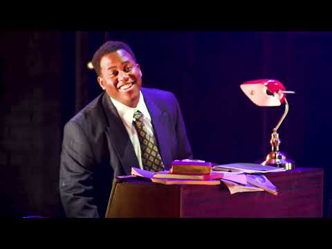 Trailer close-up: spotlight on a singer at Fat Sam’s speakeasy, bandstand visible