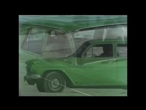 EJ Holden v Mazda RX4 on the streets of Melbourne in 1979 ‘Gold’ by John Stewart.Sept 1939-Jan 2008.