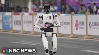 Humanoid robots race runners at Beijing half marathon