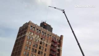 Easy does it! Men are 14 stories up in downtown Pontiac with a job to do #pontiac