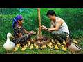 The CEO and the old lady happily cradle the beautiful ducklings, the newest members of the farm.