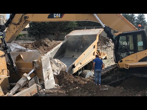Caterpillar 385C Excavator And Caterpillar D9T Dozer Loading Huge Concrete Blocks On Dumpers