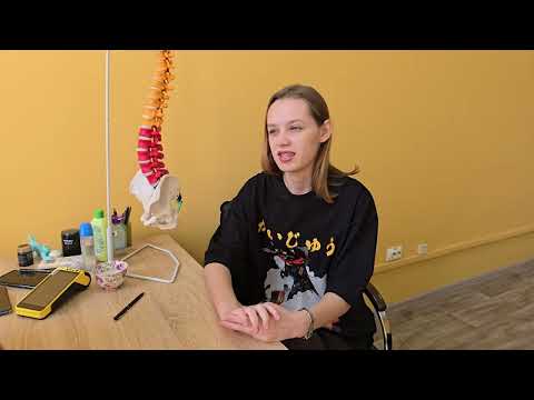 A slender girl with scoliosis at a chiropractor's appointment.