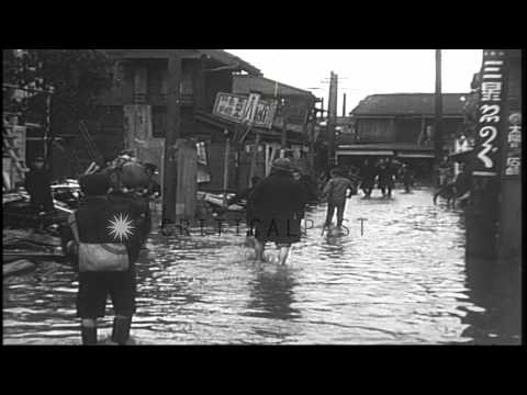 People walking with their belongings in an area affected by floods in Tokyo, Japa...HD Stock Footage