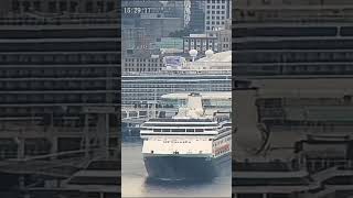Zaandam sails below Discovery Princess movie screen