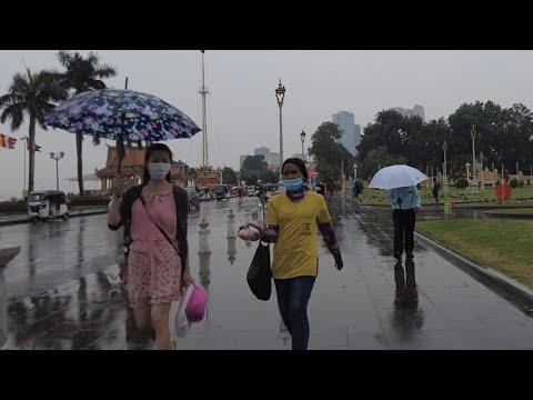 Walking the wet street of rainy Phnom Penh in evening