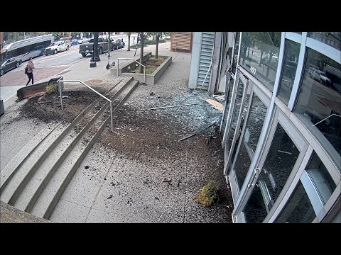 Out-Of-Control Tesla Crashes Through Convention Center Wall