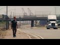 man walks alone in heat on california desert highway roads