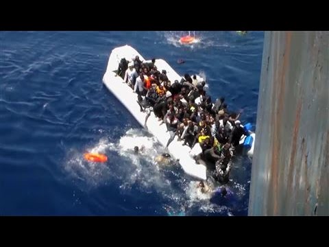 Migrants Flee Sinking Dinghy in Dramatic Footage