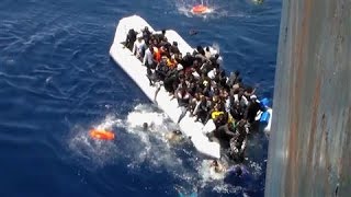 Migrants Flee Sinking Dinghy in Dramatic Footage
