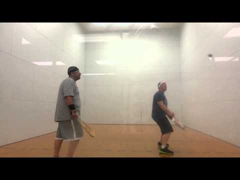 2 fat guys playing racquet ball.