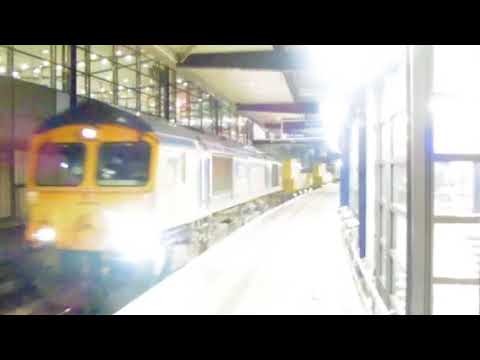 GB 66730 leads a SITT through Ashford platform 1, with 66729 on the rear.