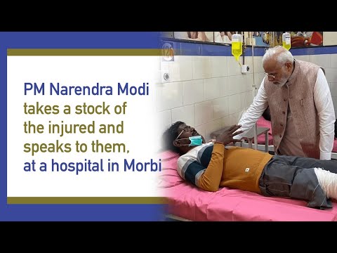 PM Narendra Modi takes a stock of the injured and speaks to them, at a hospital in Morbi l PMO

