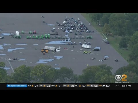 Workers setting up migrant relief center at Orchard Beach