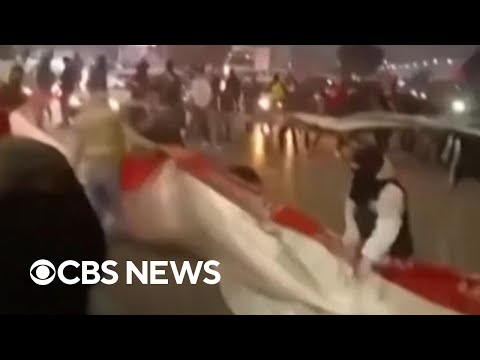Protesters rip Iranian flag as anti-government protests heat up