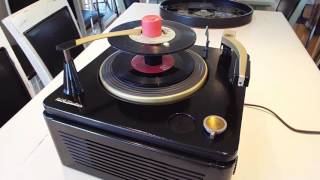 RCA record player playing a stack of 45 RPM records.