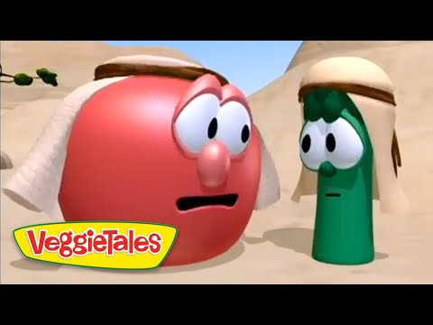 Red tomato and green cucumber VeggieTales characters wearing desert head coverings, talking in a sandy canyon with the VeggieTales logo in the lower-left corner.
