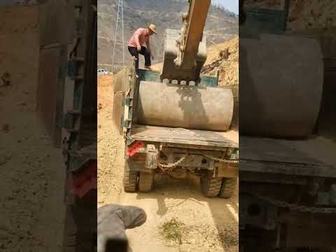 Excavator unloading concrete water pipe