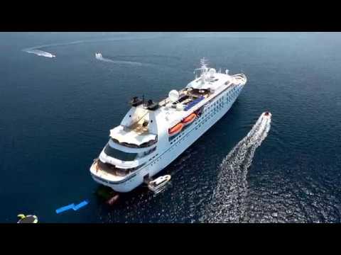 Windstar Cruise ship with smaller boats on the water