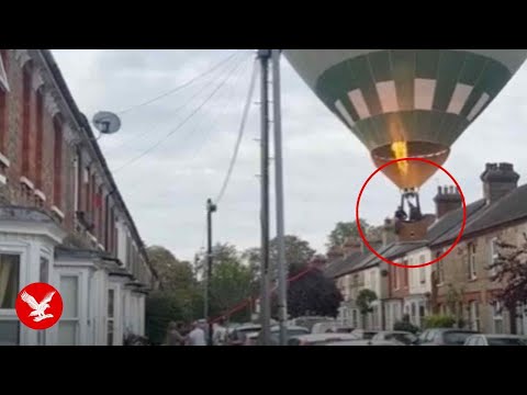 Moment hot air balloon lands on street in front of stunned residents