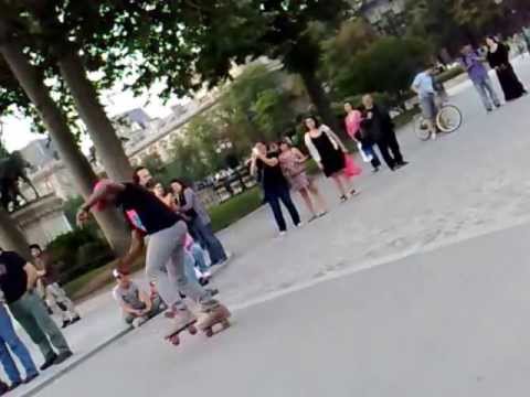 this guys jump over a stick on their roller skates