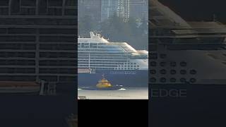 Edge sailaway with tug escort past Stanley Park in Vancouver